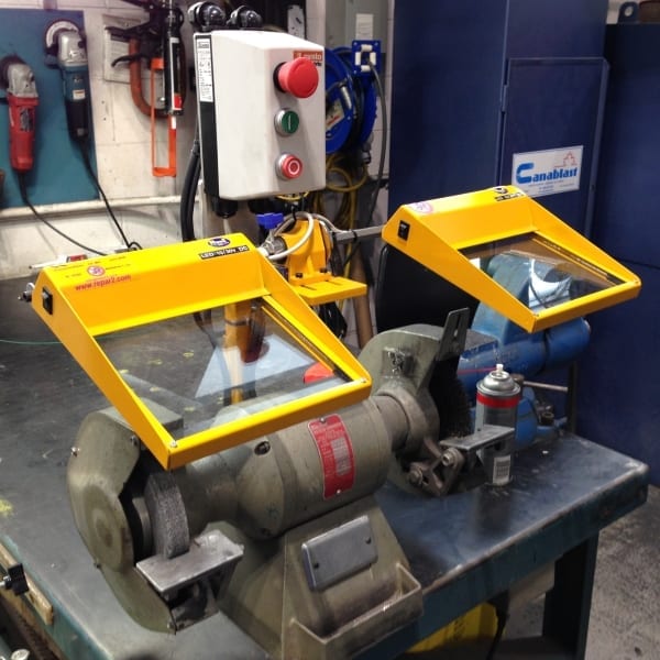 Safety guard installed on a bench grinder