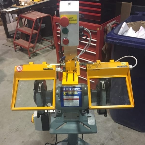 Small bench grinder with large safety shields.