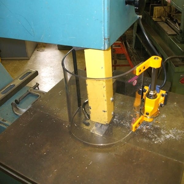 Curved safety shield installed on a band saw.