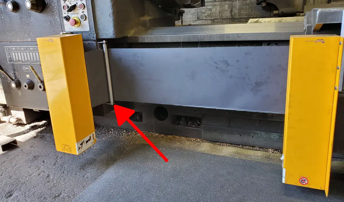 An example of a flat installation point for a lathe chuck safety shield. An arrow points to the mounting bracket.