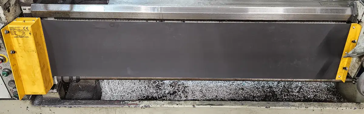 An example of a flat installation point for a lathe chuck safety shield. An arrow points to the mounting bracket.