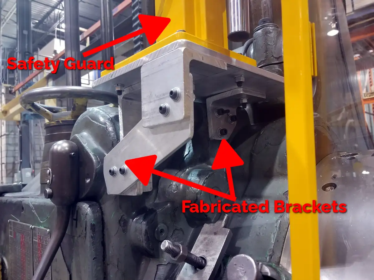An example of a flat installation point for a lathe chuck safety shield. An arrow points to the mounting bracket.