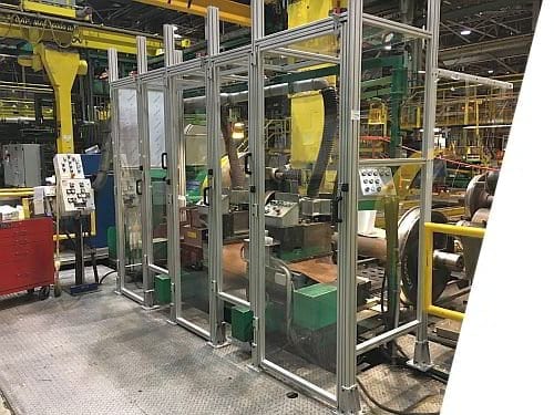 Custom machine guard designed to fit a train wheel lathe.  Features multiple clear polycarbonate window doors with interlocks.