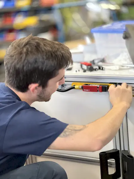 Ferndale Safety technician installing a safety interlock switch