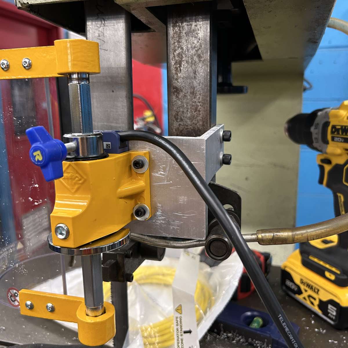 An example of a custom-fabricated mounting bracket used to mount a Ferndale Safety band saw safety guard.