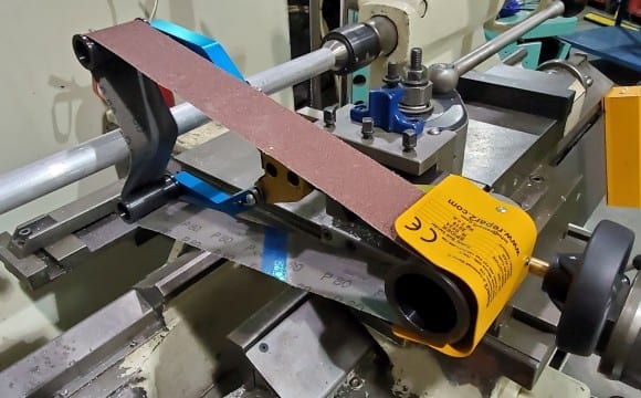 Lathe belt sander attachment for polishing.