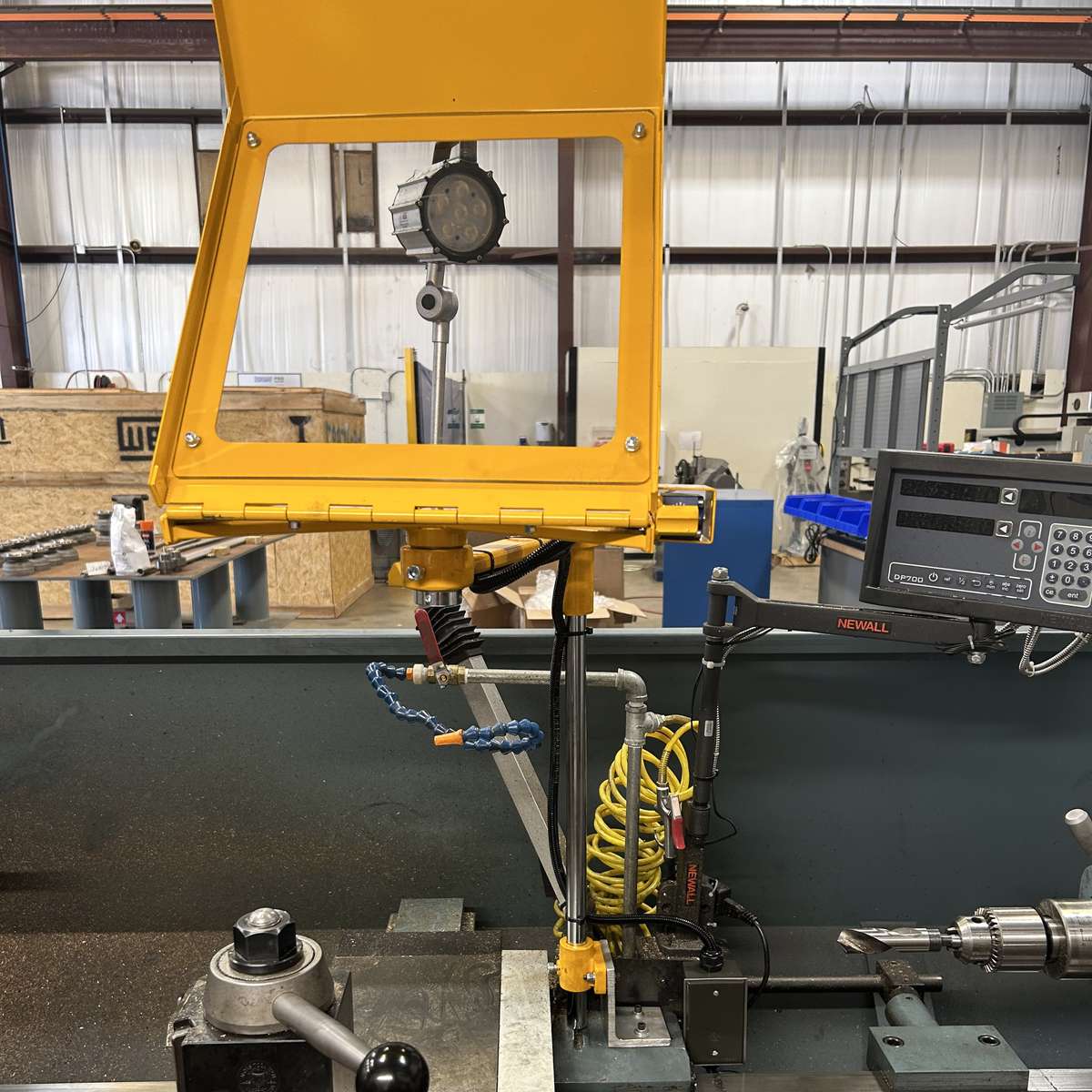 A Ferndale Safety chip shield installed on the carriage of a lathe, showing the guard in its open position.