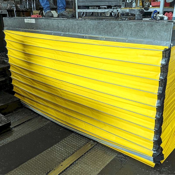 A closeup of a lift table with the scissor mechanism covered with bellows.