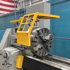 A photo of a sliding lathe chuck guard installed on a big lathe.