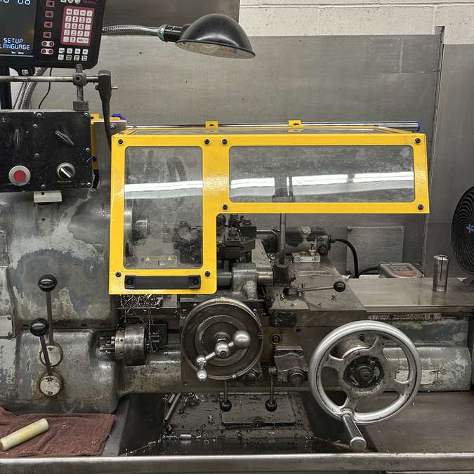 A Ferndale Safety small lathe chip guard shown installed on a lathe.