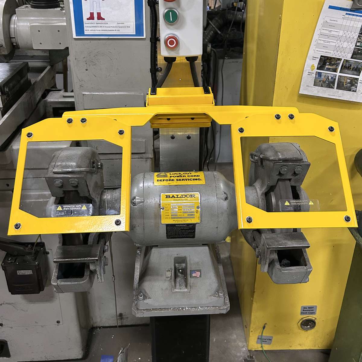 A photo of the Viziguard bench grinder guard installed on a standard bench grinder.